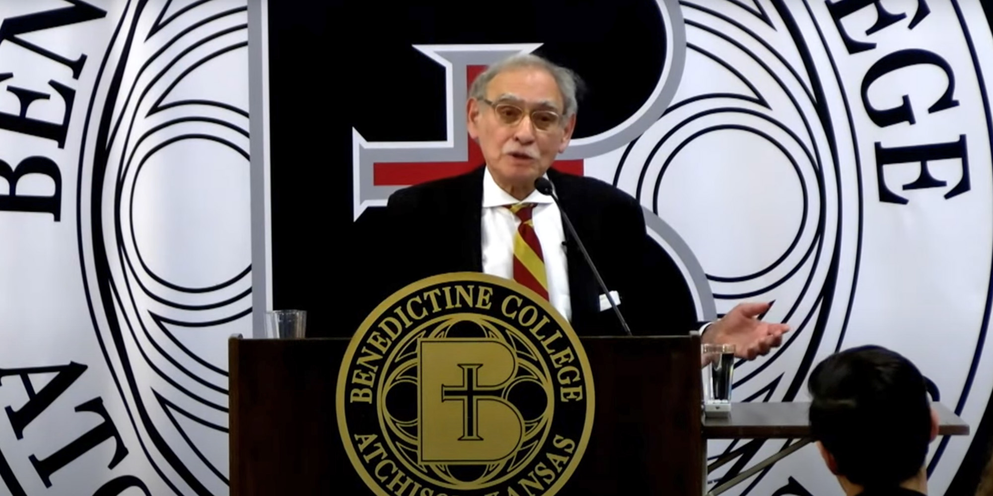 Hadley Arkes speaks at the podium during a lecture at Benedictine College