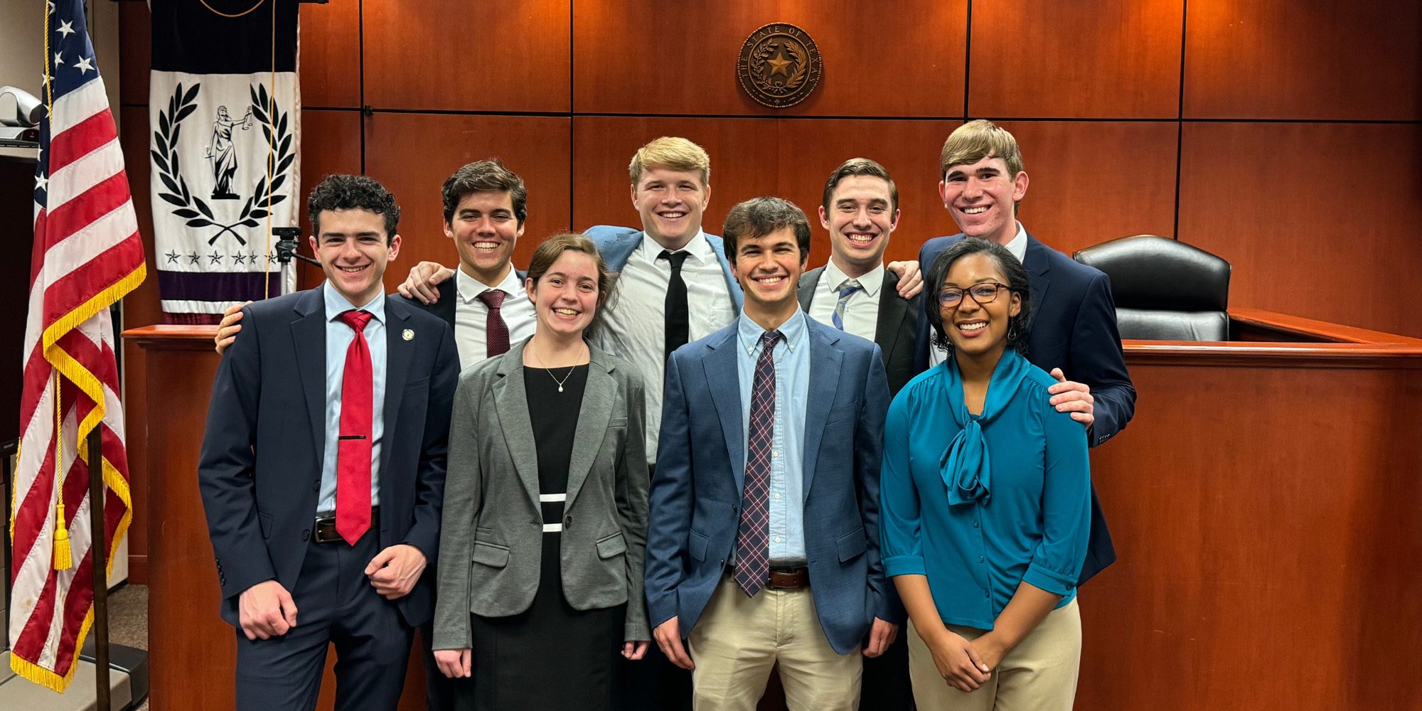 Benedictine College's 2023 moot court team poses for a photo in a courtroom
