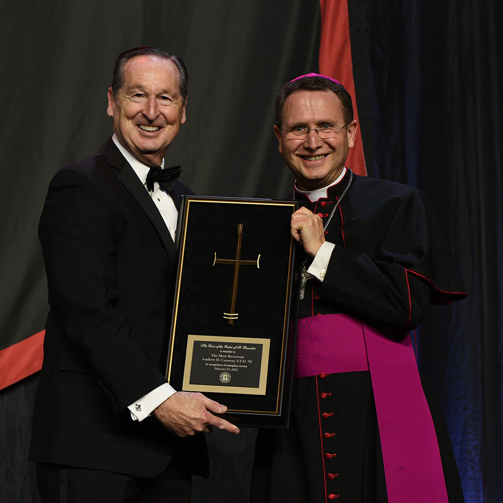 President Minnis holds the Cross of the Order of St. Benedict Award with the awardee, The Most Rev. Andrew Cozzens, STD ’91, Bishop of the Diocese of Crookston, Minnesota