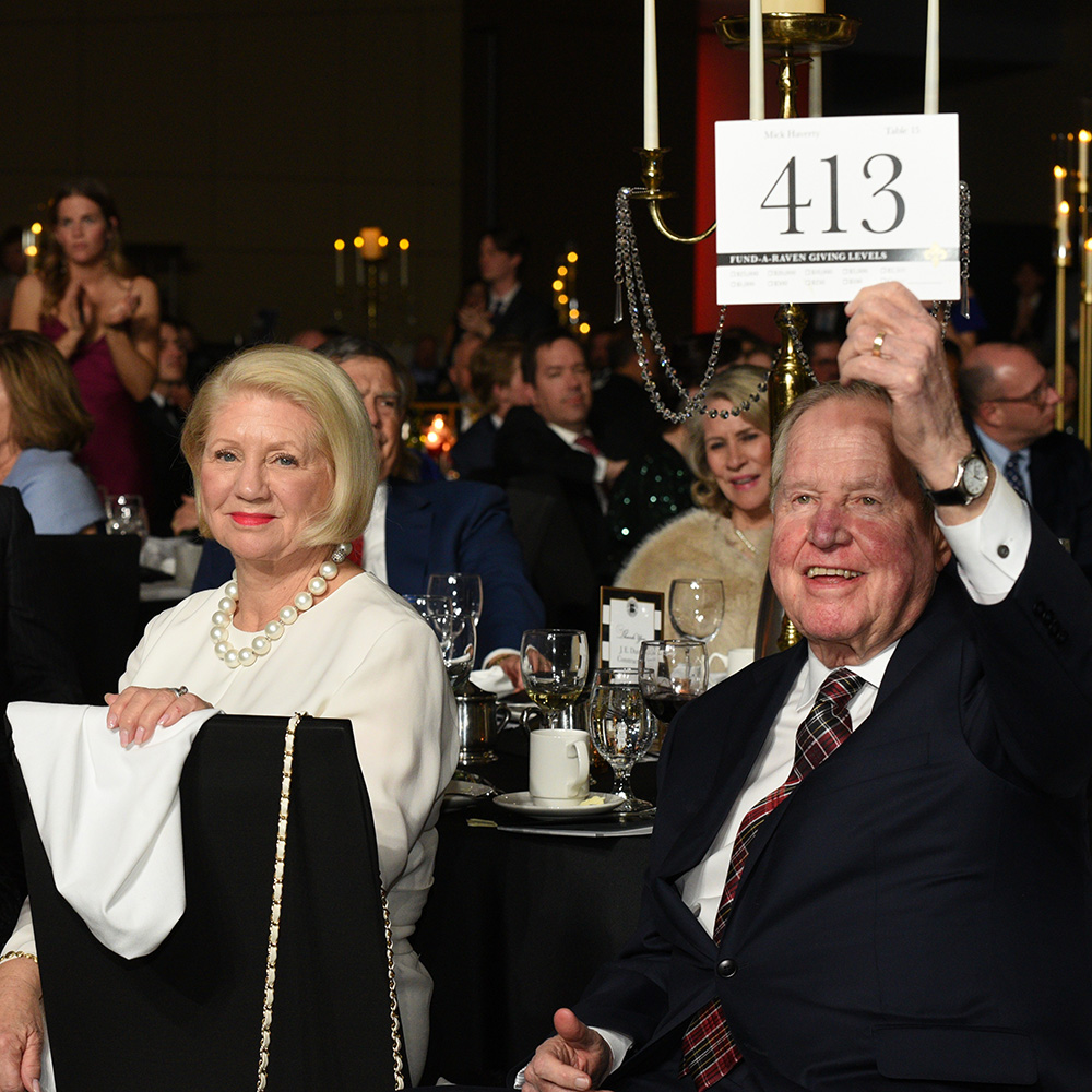 A donor raises his bid card during the Scholarship Ball