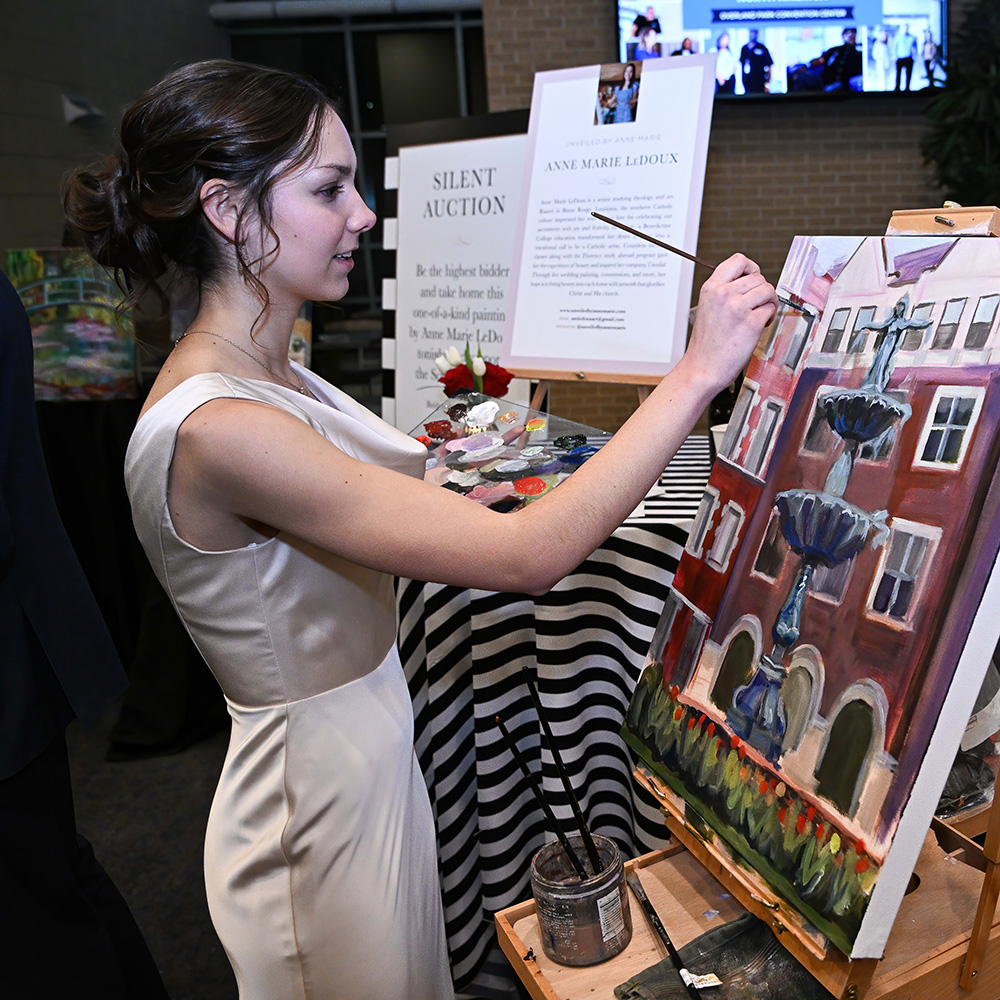 An art student paints at the Scholarship Ball