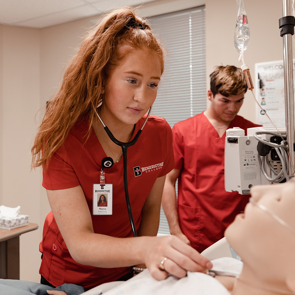 Nursing students working in a simulation lab
